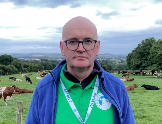 Tom Dunne in front of cows in a field